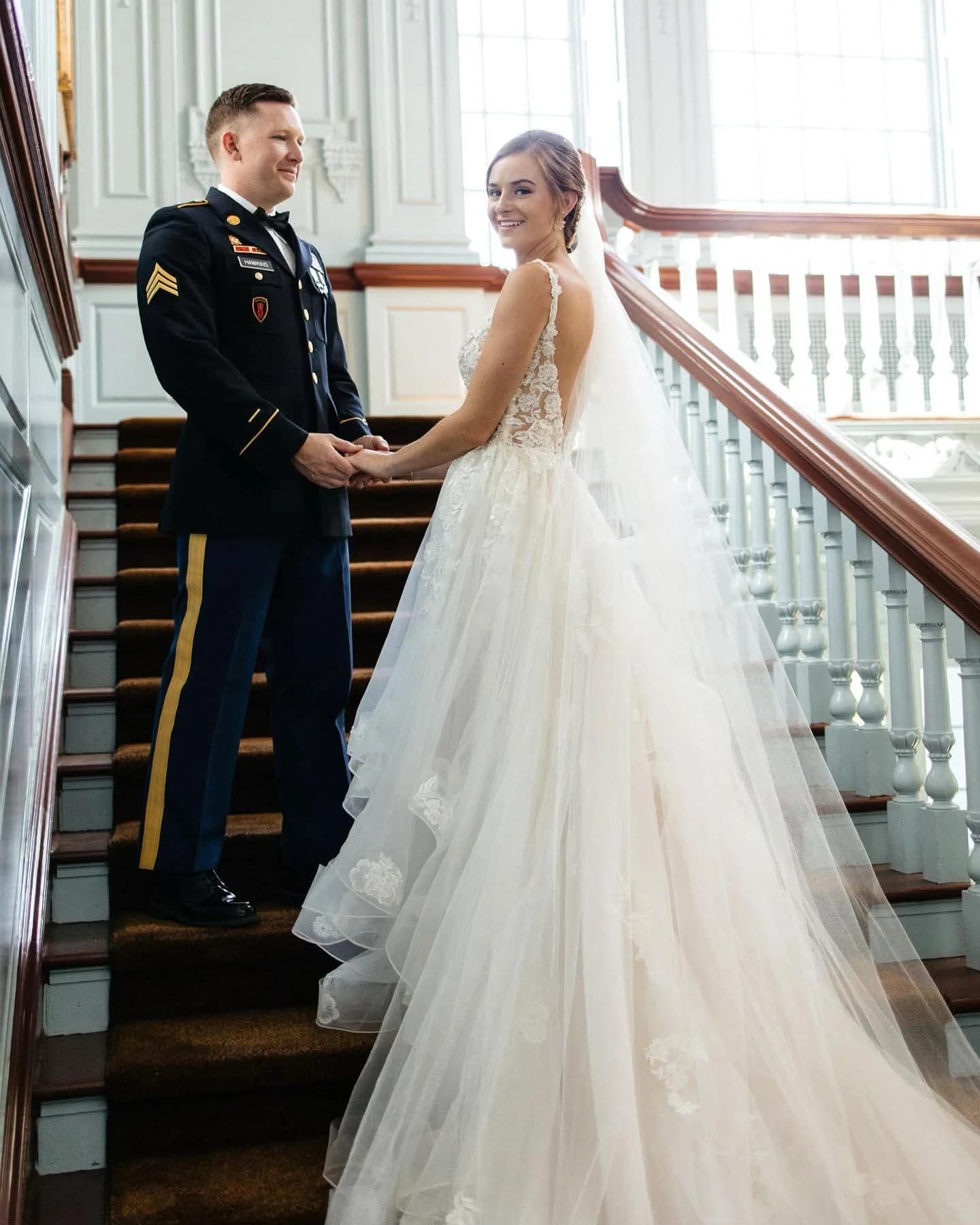 Bride on staircase with flowing veil